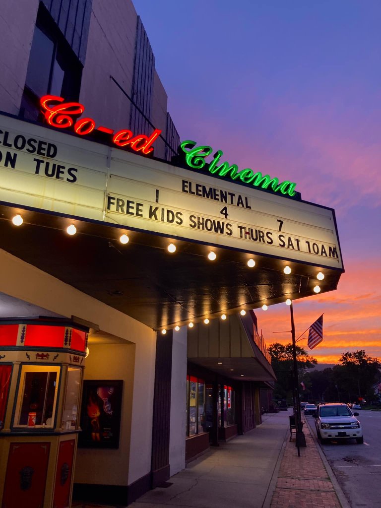 Sign of the Co-Ed Cinema in Downtown Brevard, featuring free kid shows.