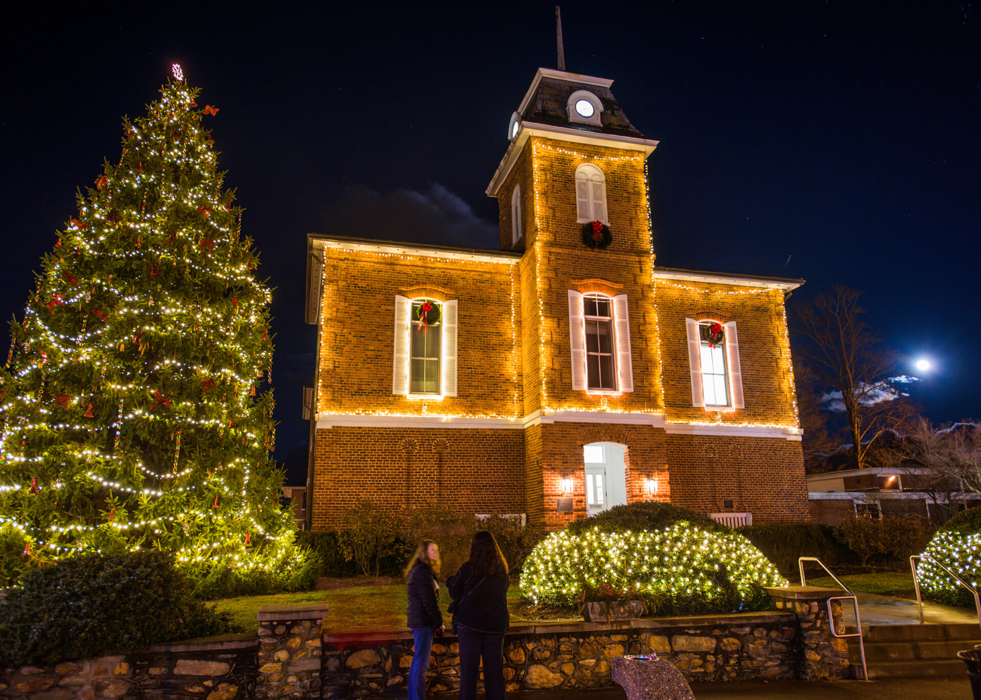 Festive Brevard Town Hall building with illuminated Christmas tree.