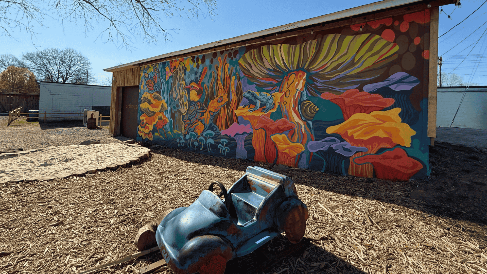 Mural at The Yard Brevard, featuring vibrant colors and local flora & fauna.