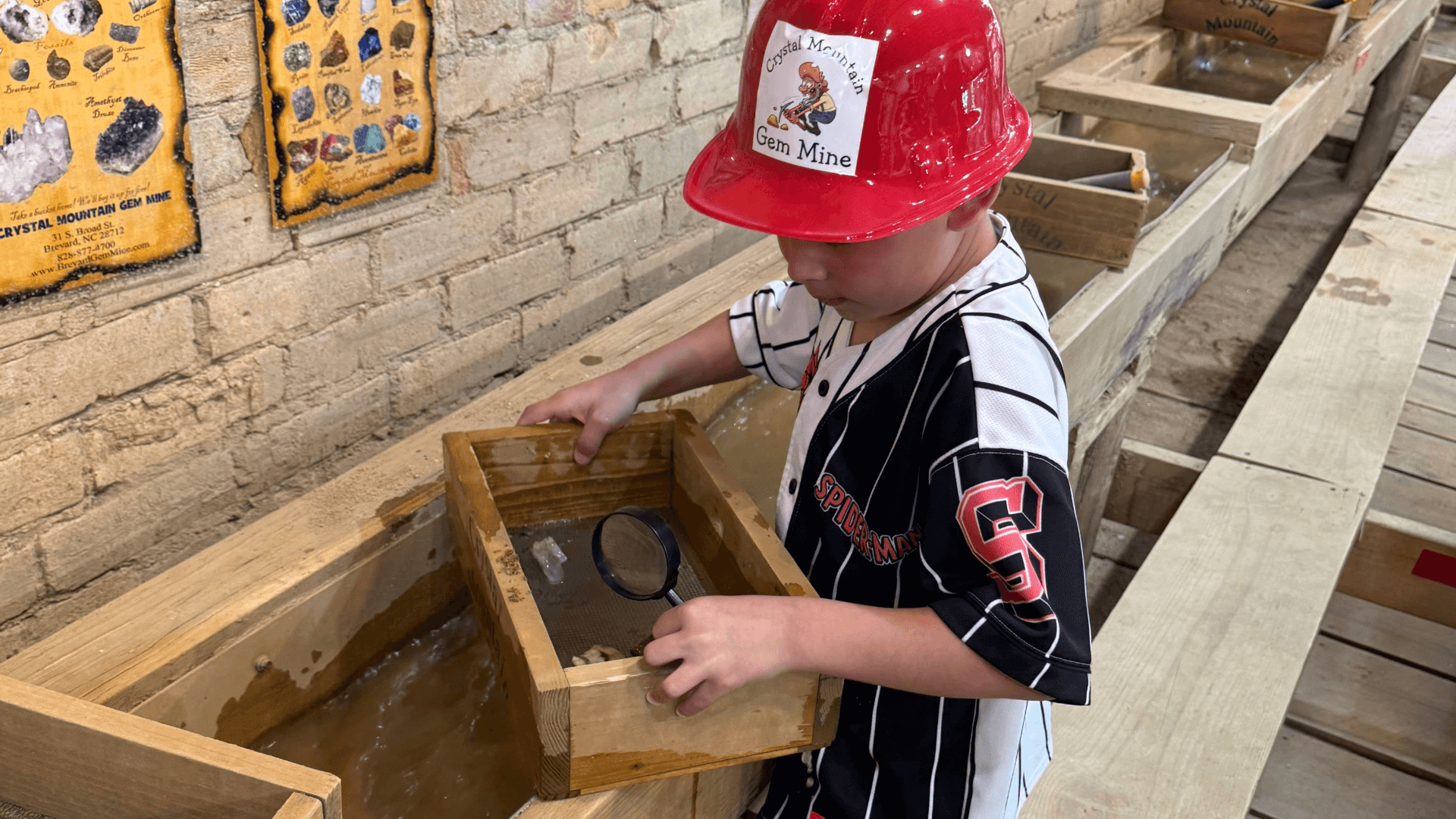 Little boy mining for gems at Crystal Mountain Gem Mine in Downtown Brevard